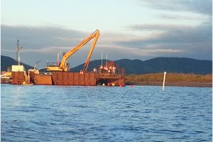 Pipestring exiting mainland cofferdam
